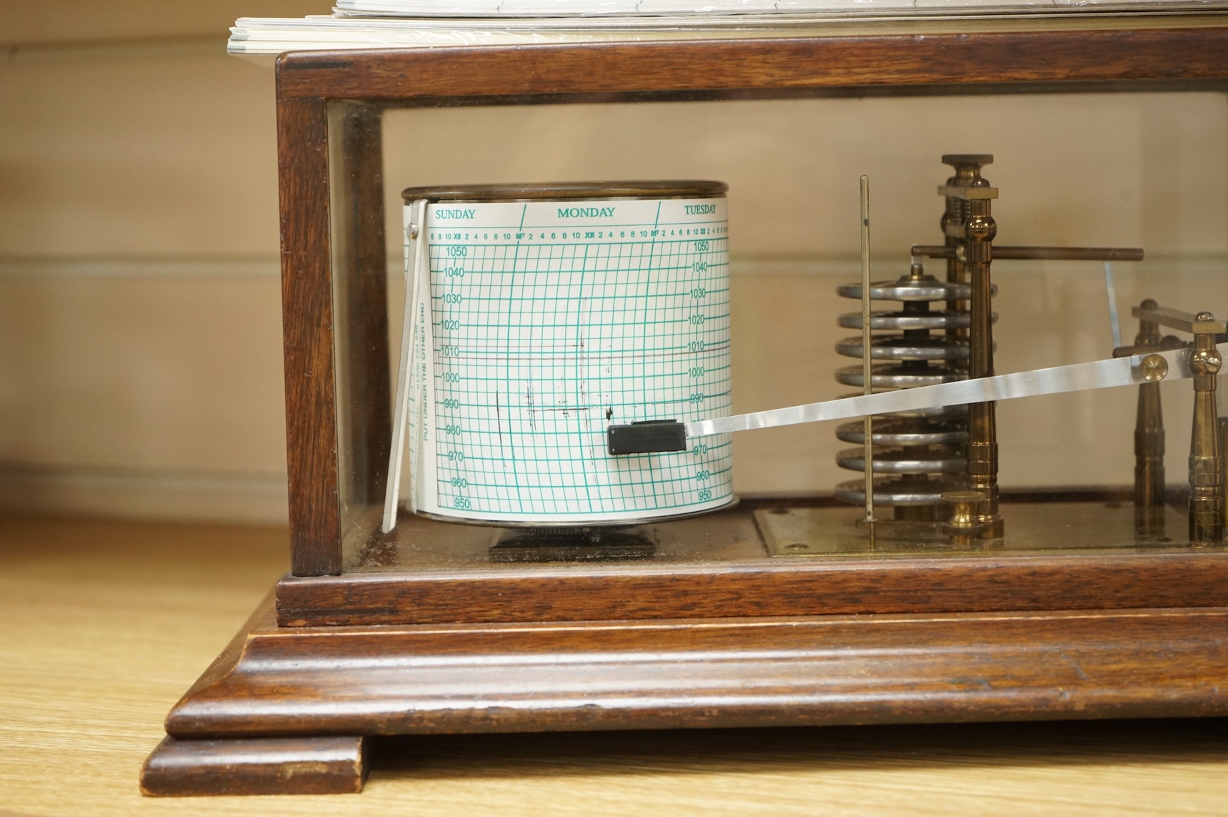 An early 20th century mahogany cased barograph by an unknown maker, with a quantity of unused papers.